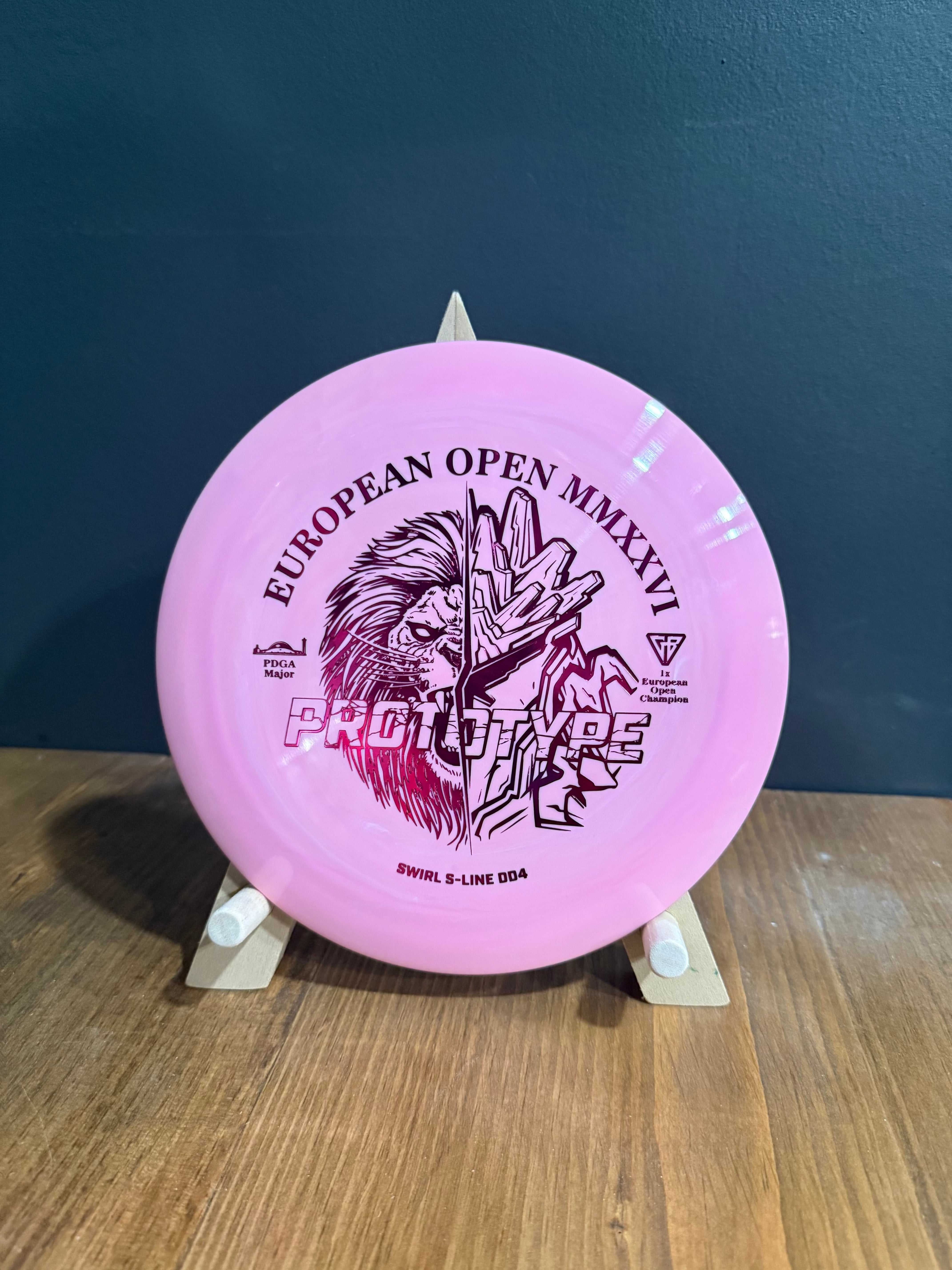 Prototype Swirl S-Line DD4 disc golf driver in pink with subtle swirls and European Open lion artwork