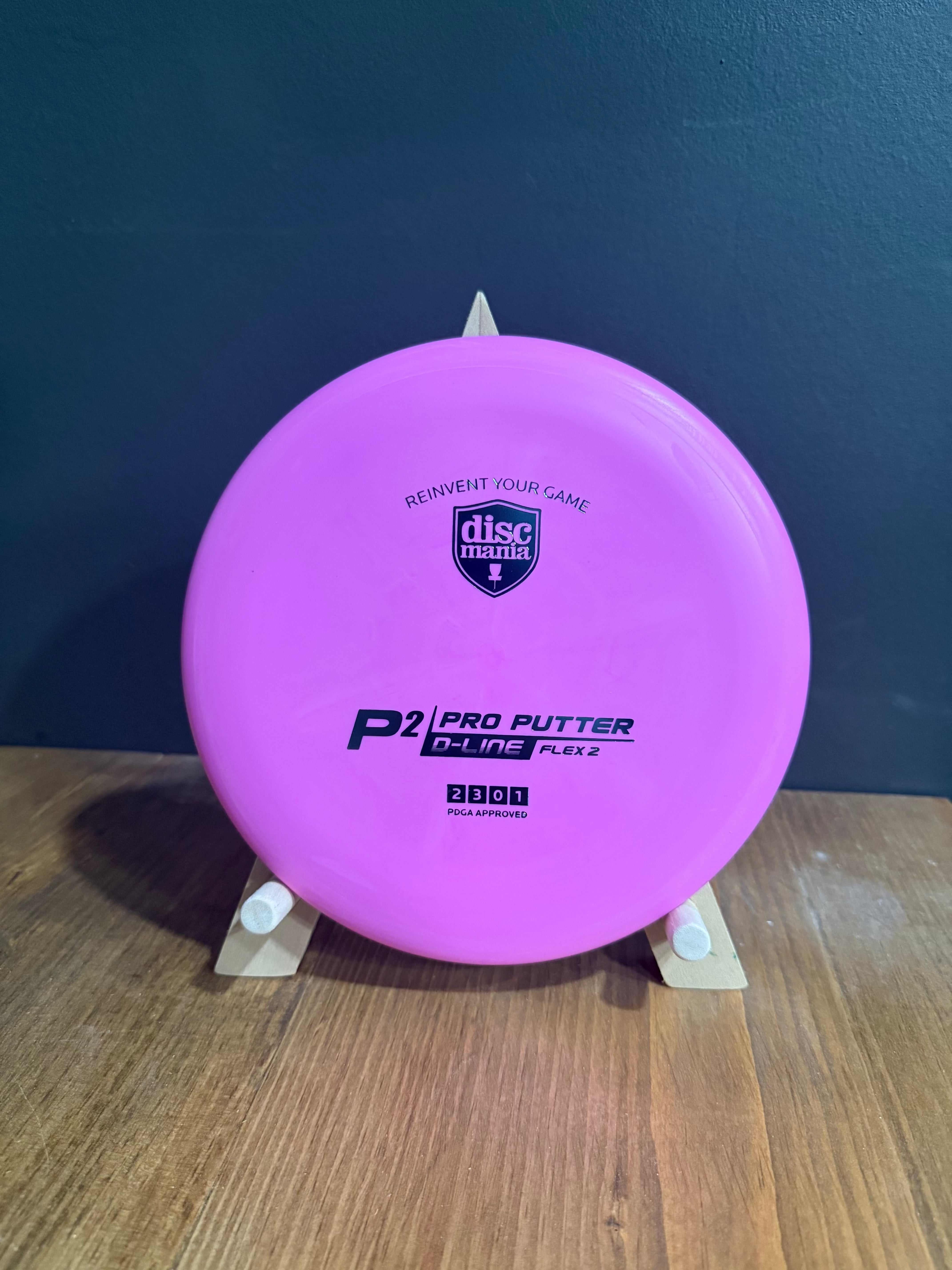 Flex 2 D-Line P2 pink plastic disc golf putter with printed branding and smooth rounded rim