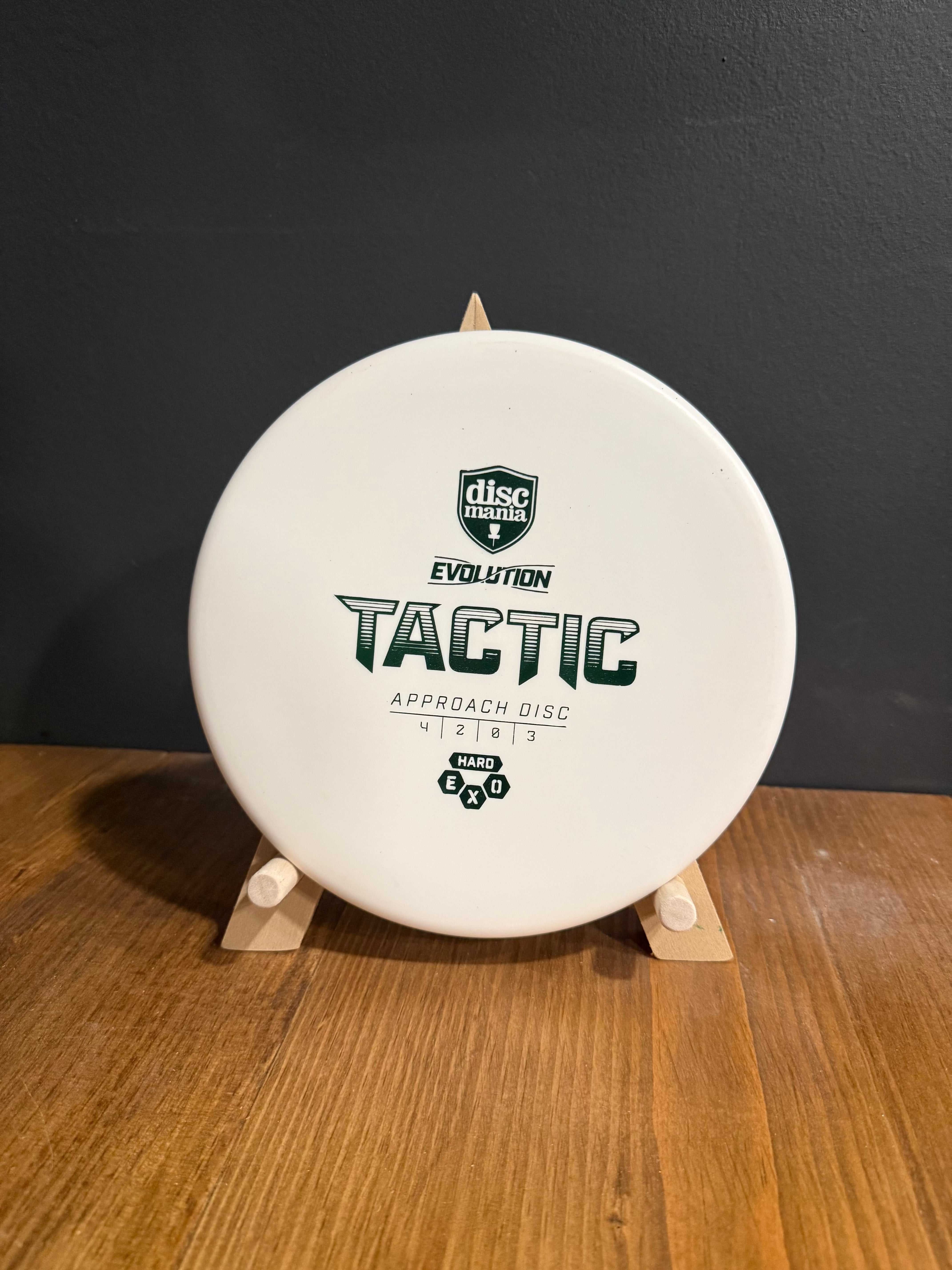 Hard Exo Tactic white disc golf putter in standard plastic, featuring bold Tactic branding and stamp details