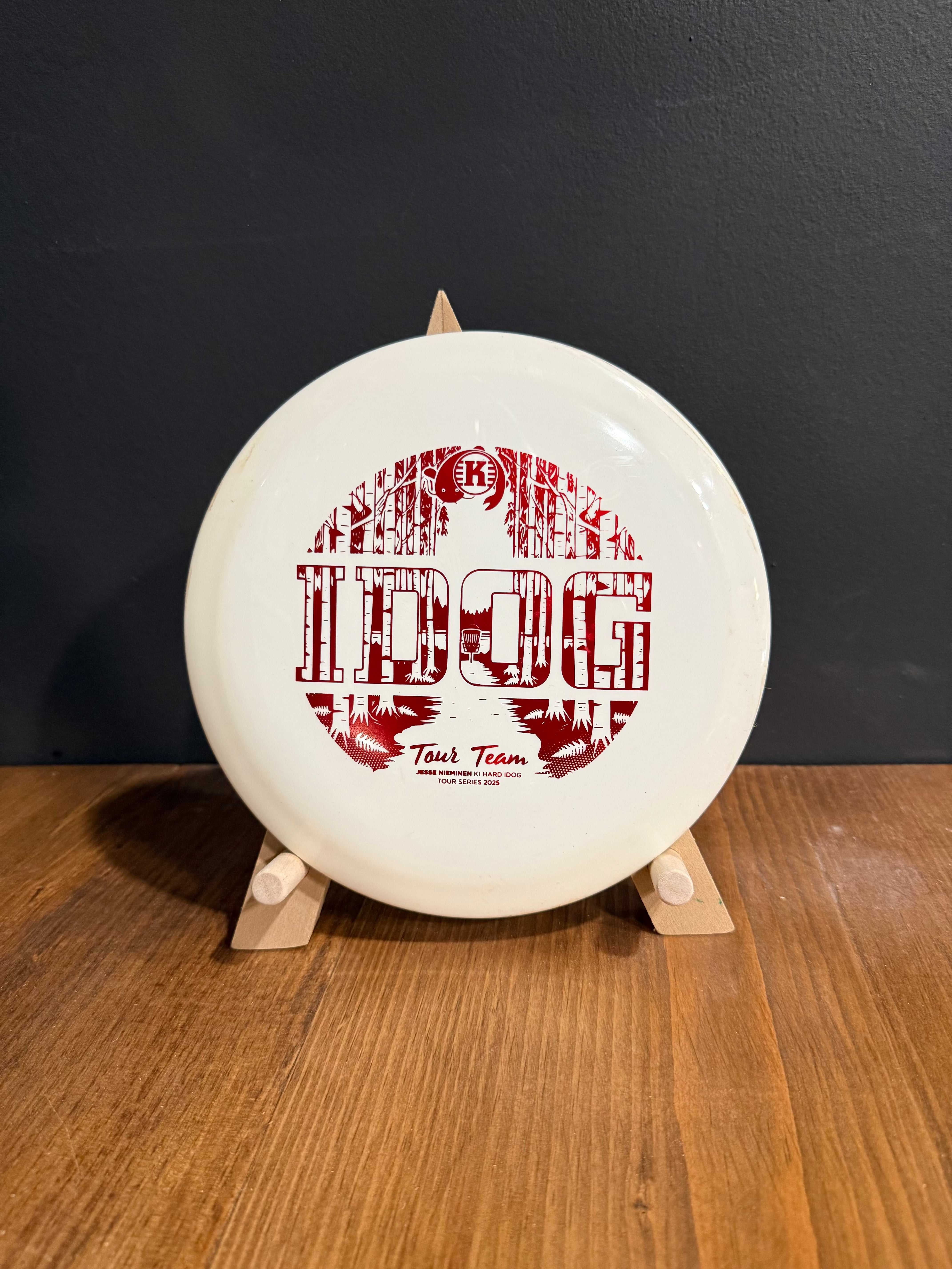K1 Hard Idog disc golf driver in white plastic with a bold red distressed Tough Team graphic and logo.