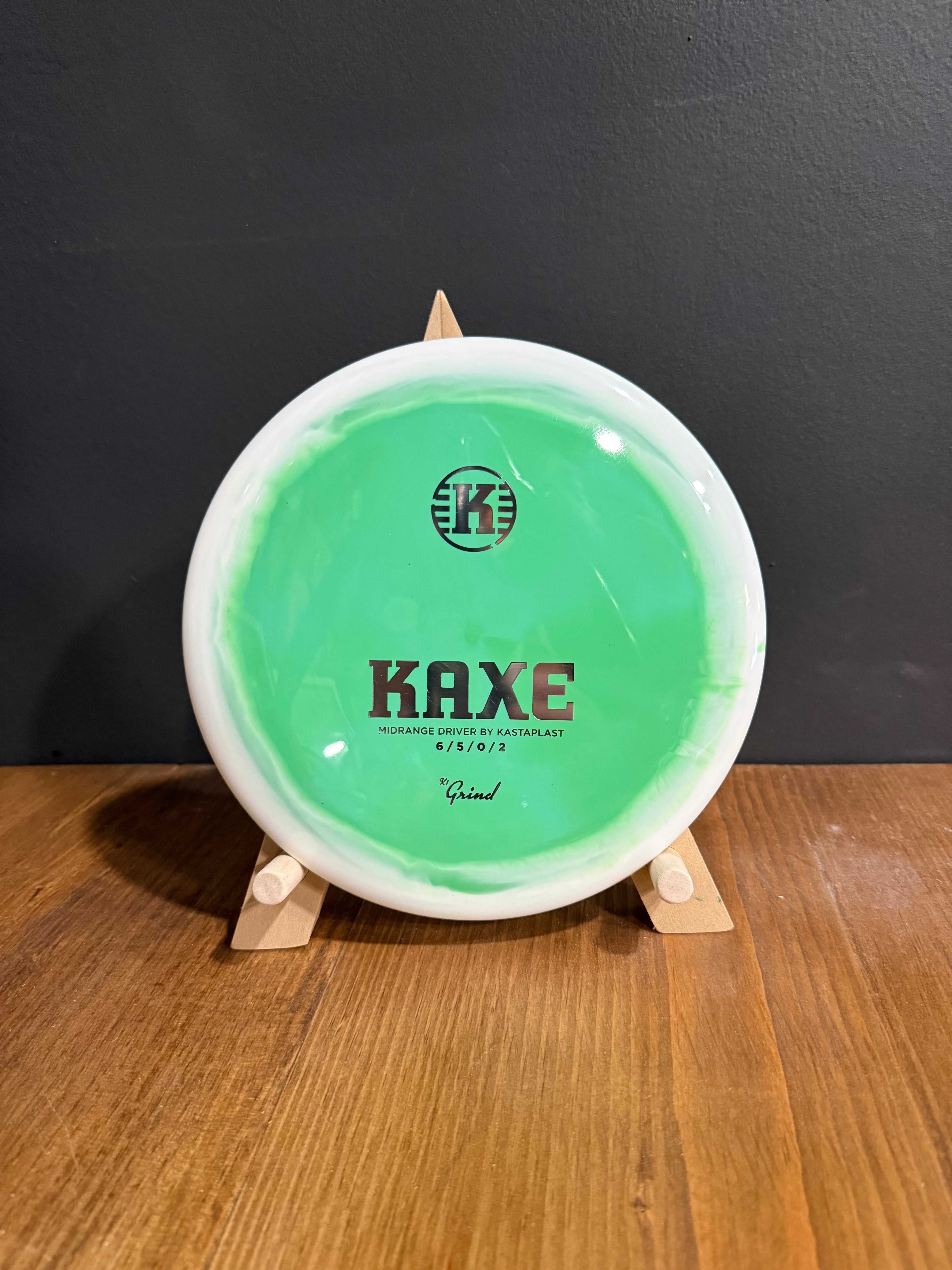 K1 Grind Kaxe disc golf disc in translucent mint green with a white rim and black printed branding