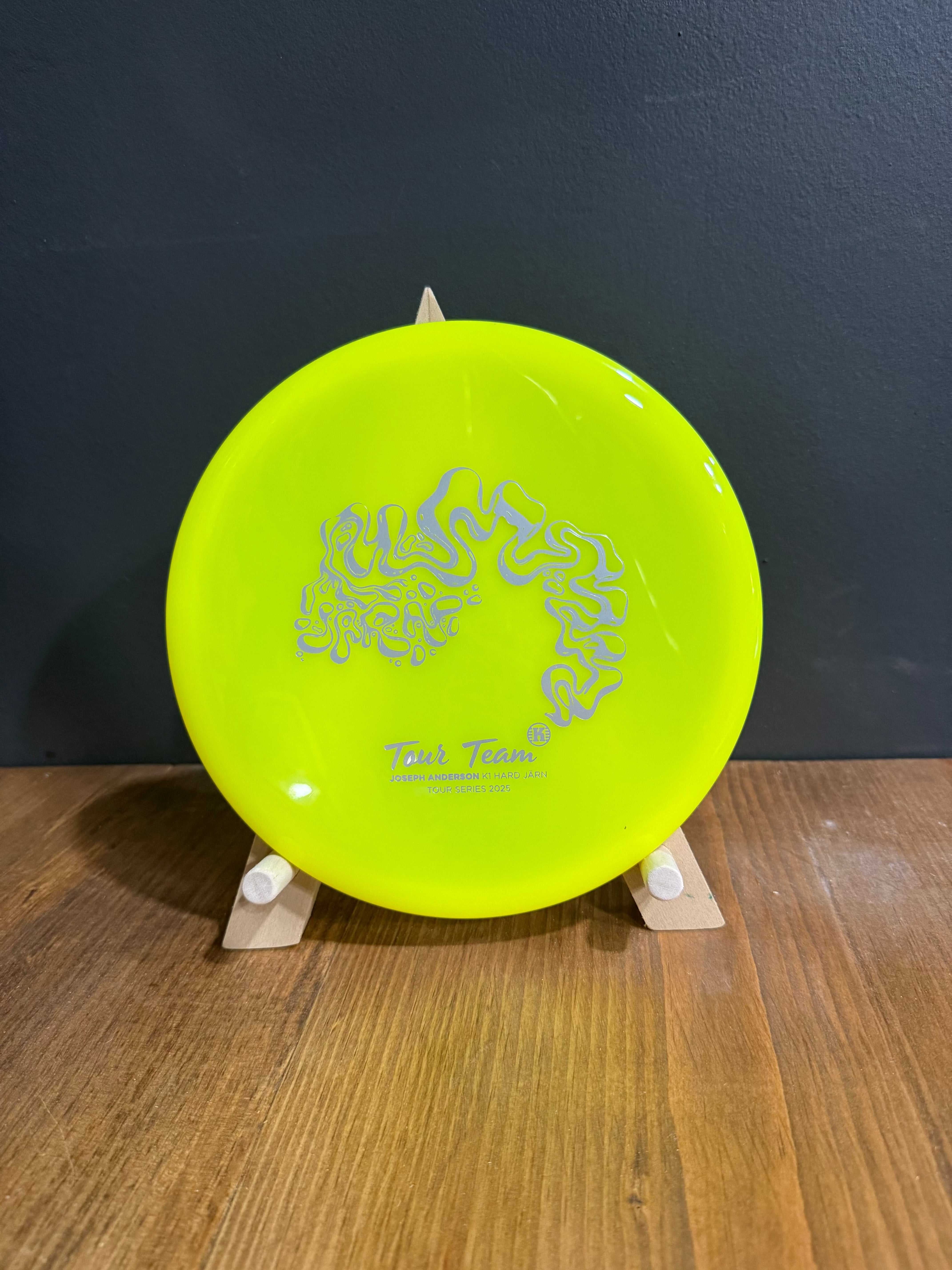 K1 Hard Jarn disc in fluorescent yellow K1 plastic with silver Tour Series artwork and low-profile rim