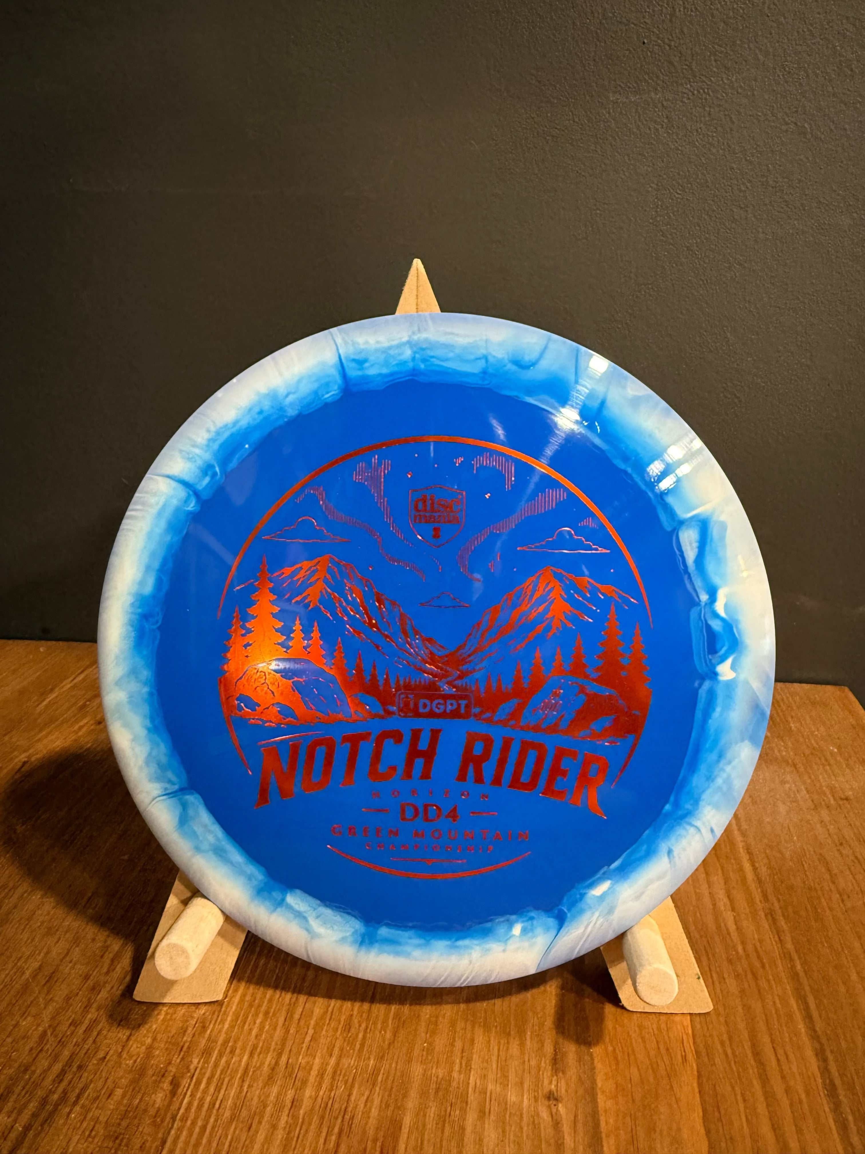 Notch Rider blue Horizon S-Line DD4 disc with white marbled rim and red mountain graphic
