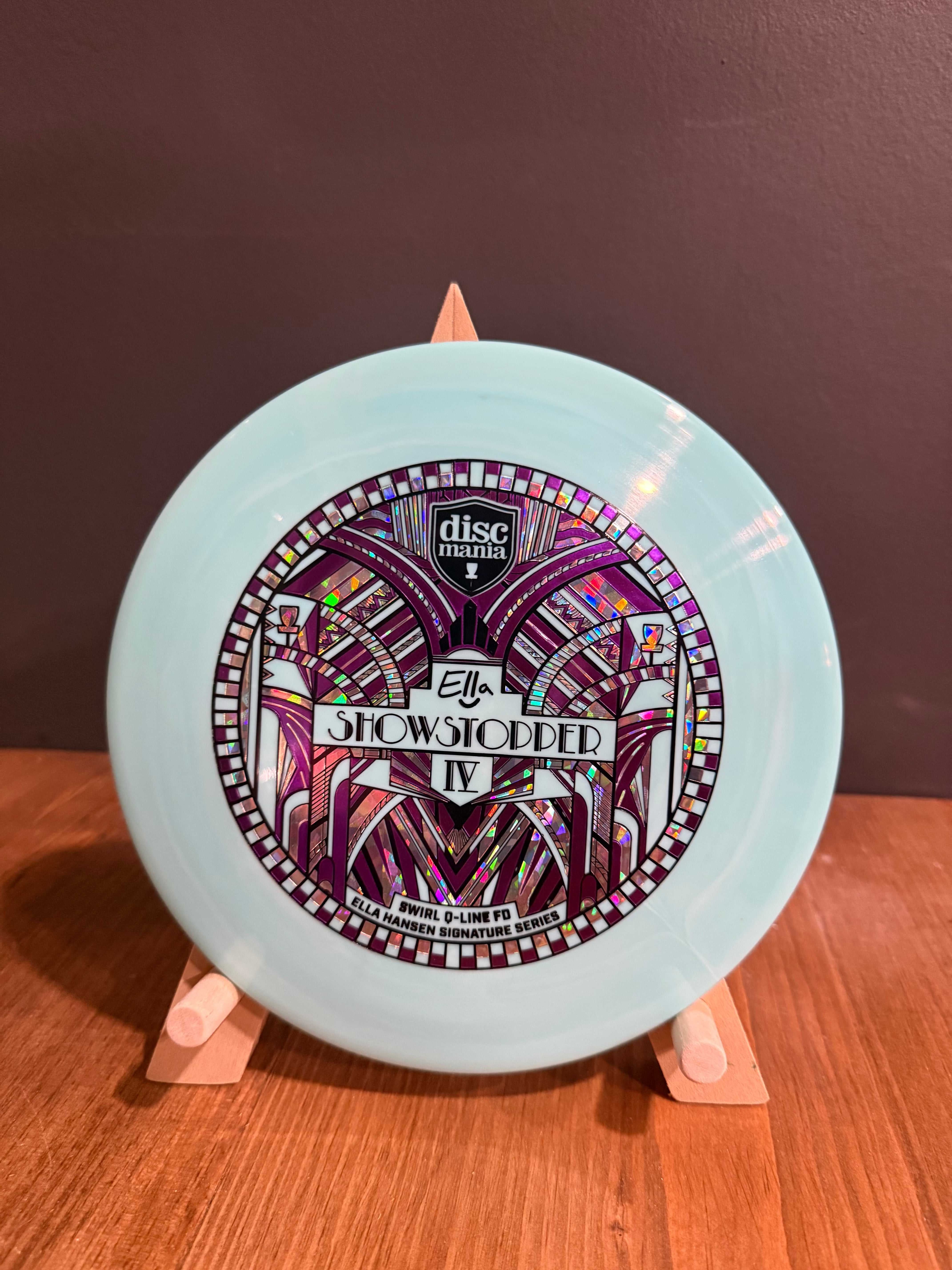 Show Stopper 4 disc golf driver in pale blue plastic with colourful stained-glass swirl stamp and beaded rim pattern