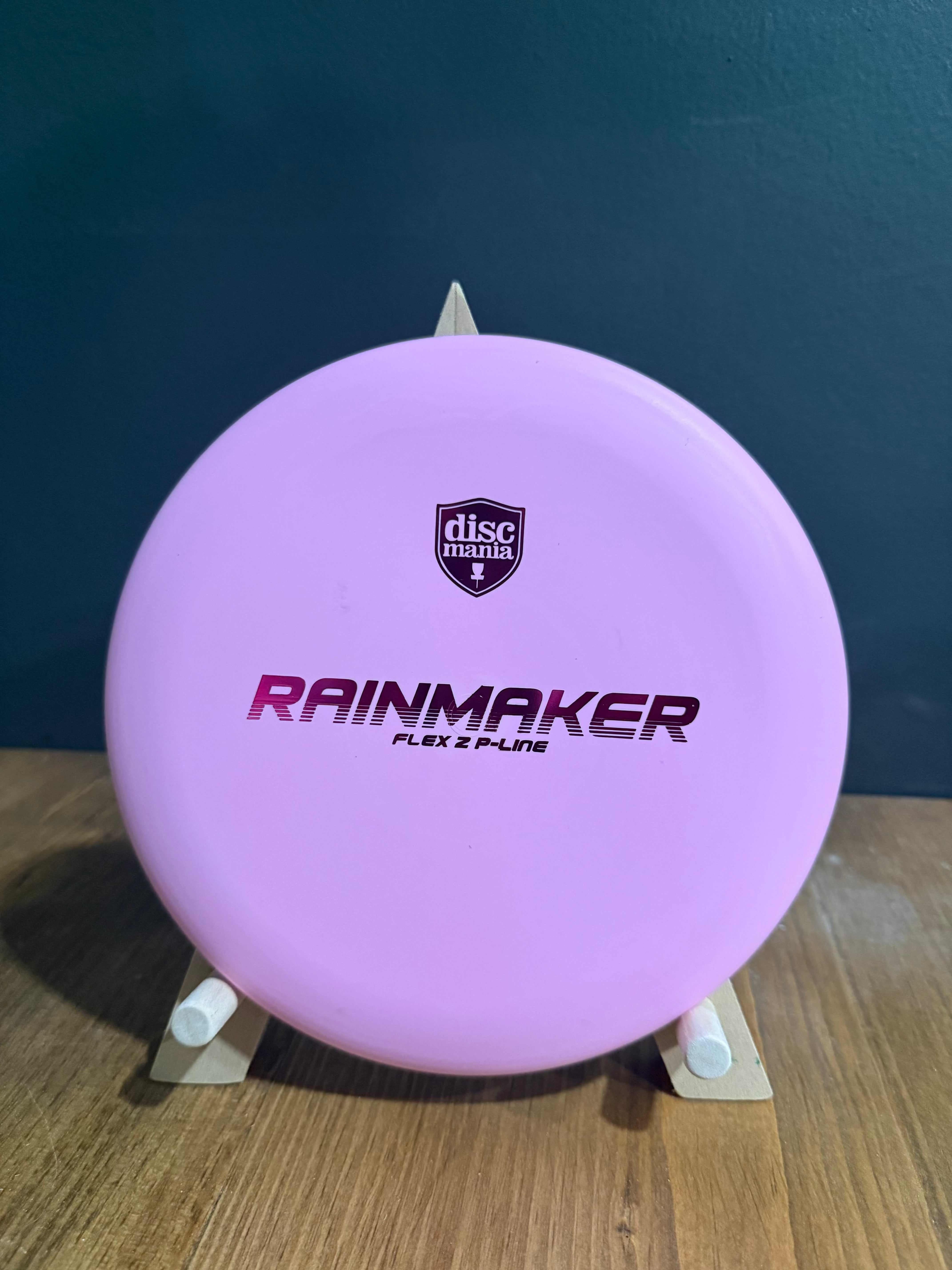 Putter disc in lavender P-line plastic, featuring Rainmaker branding and Flex 2 P-Line lettering on top
