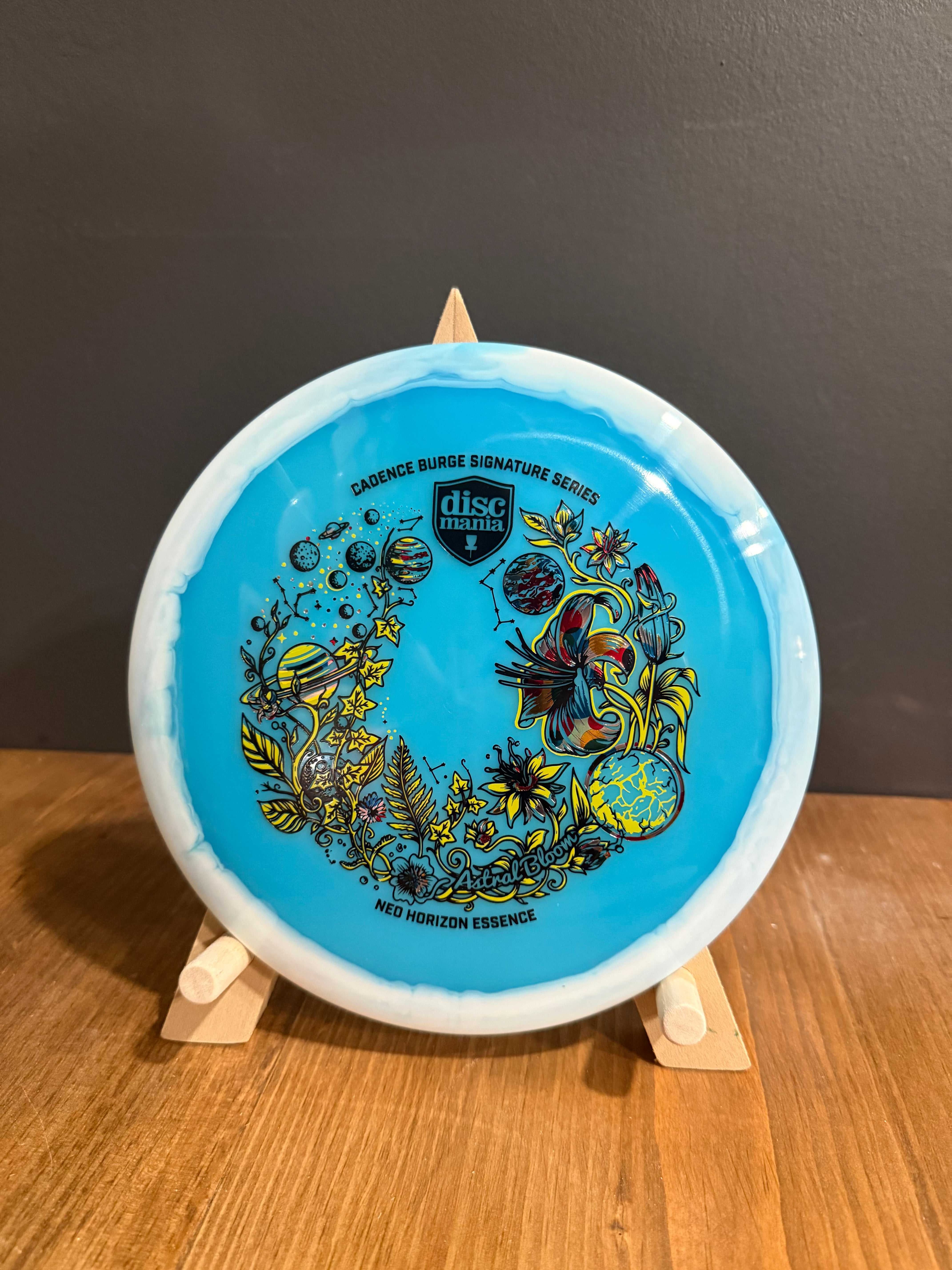 Astral Bloom blue Neo Horizon disc golf driver with white rim and intricate triple-foil floral artwork
