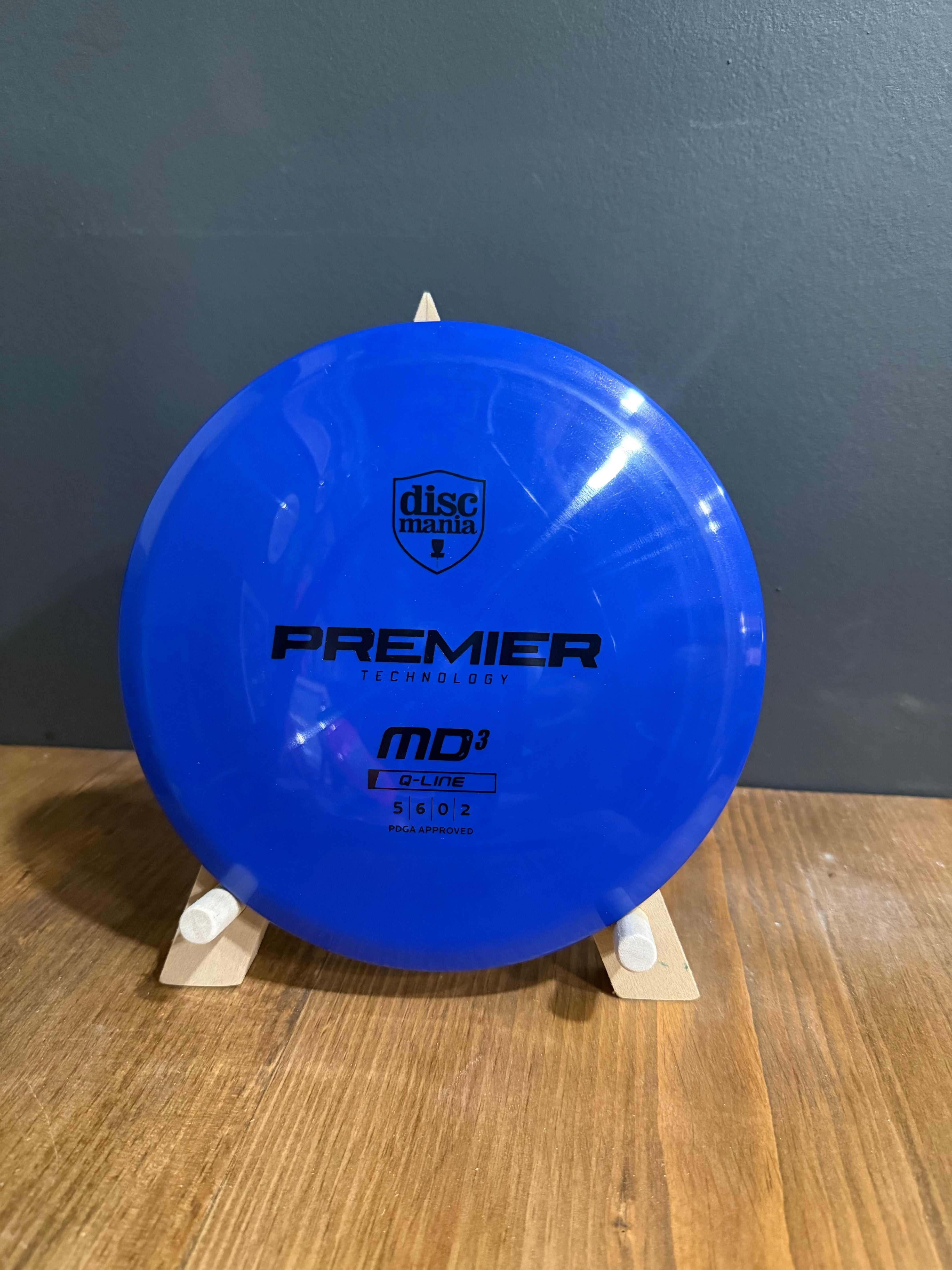 Q-Line Premier MD3 blue disc golf disc, glossy plastic with black printed branding and model markings