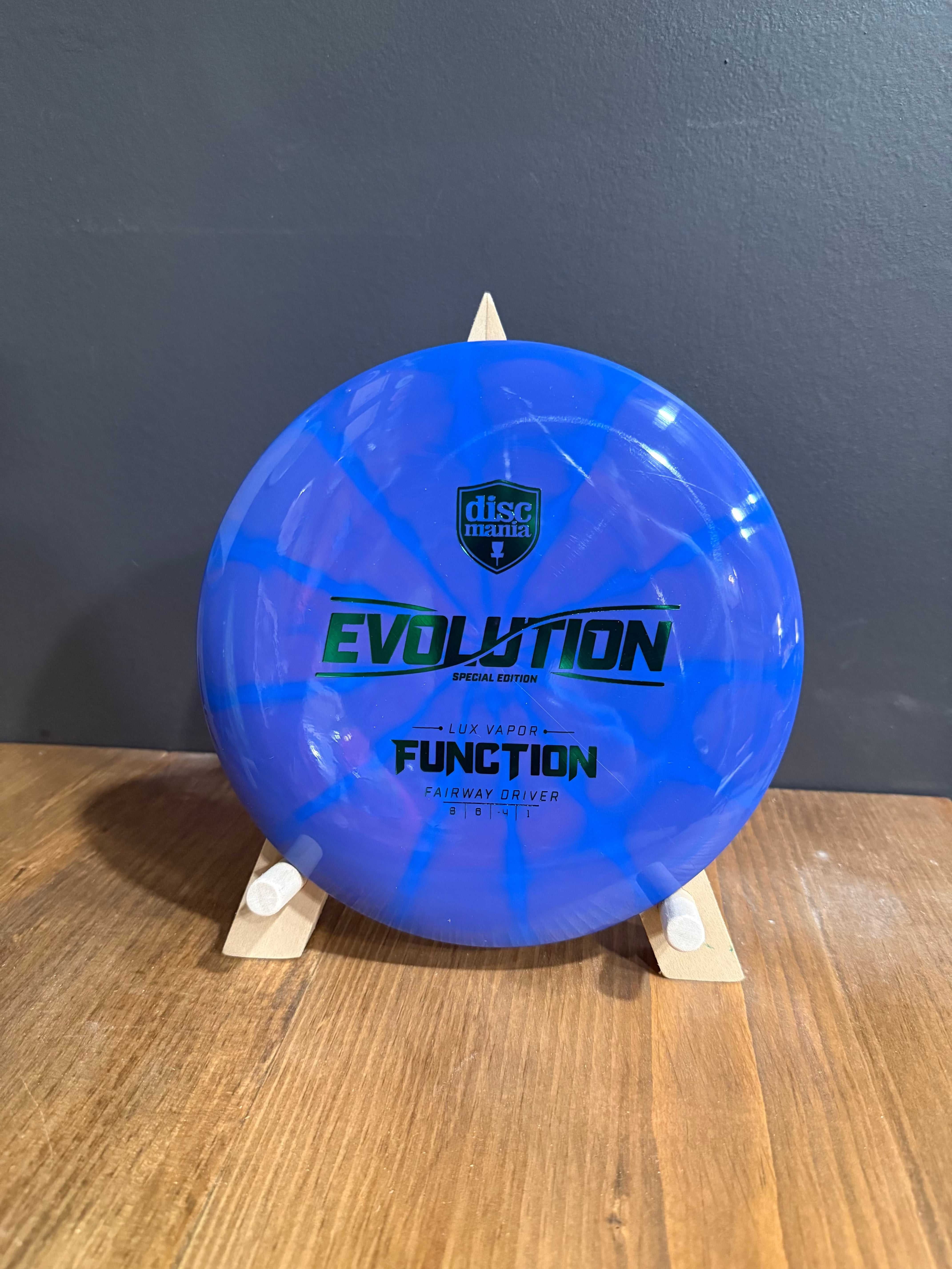 Lux Vapor Function disc golf driver in translucent blue plastic with vivid marbled vapor effect and printed branding