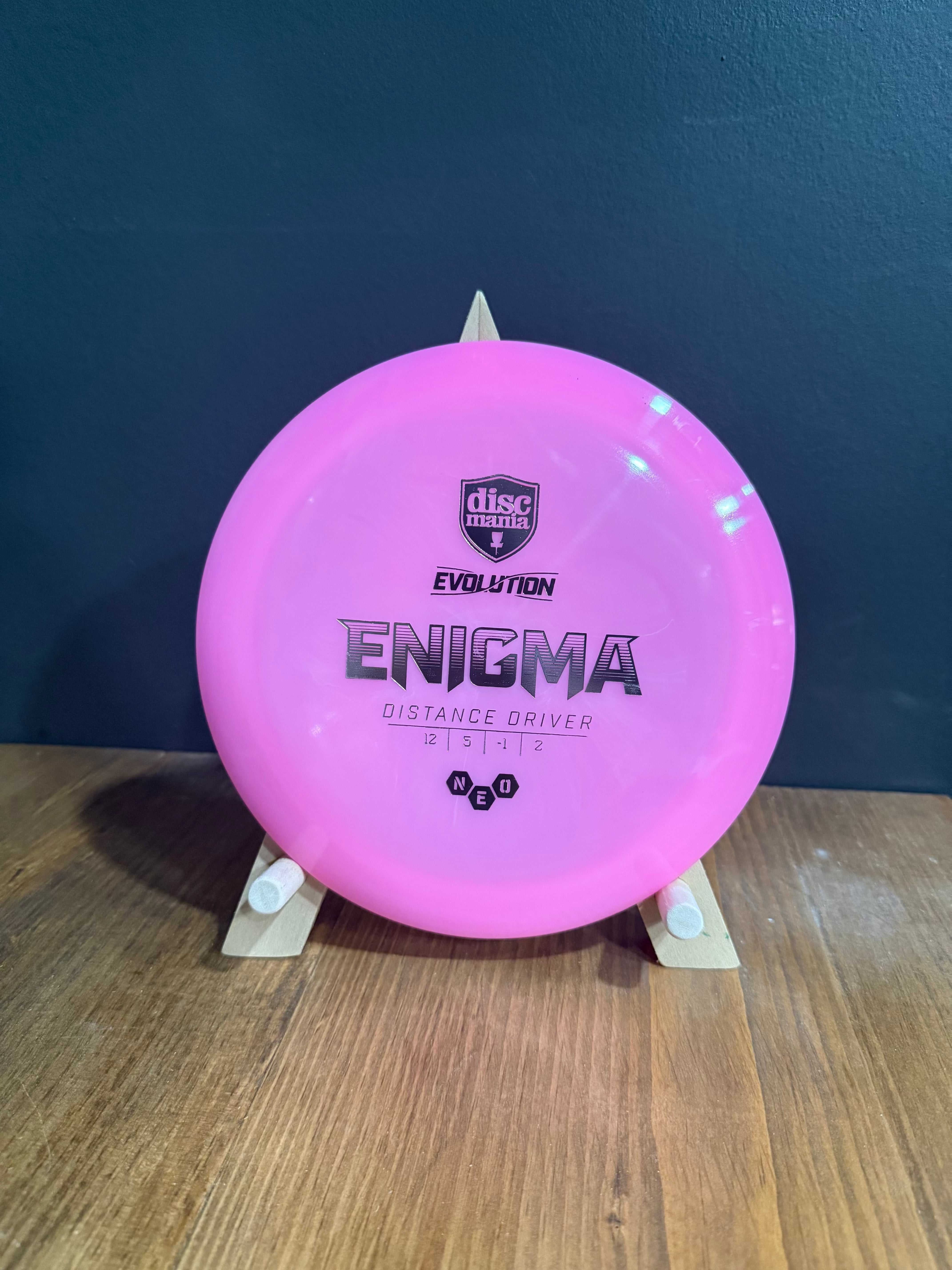 Neo Enigma pink Neo plastic distance driver disc with Evolution branding and bold black printed graphics