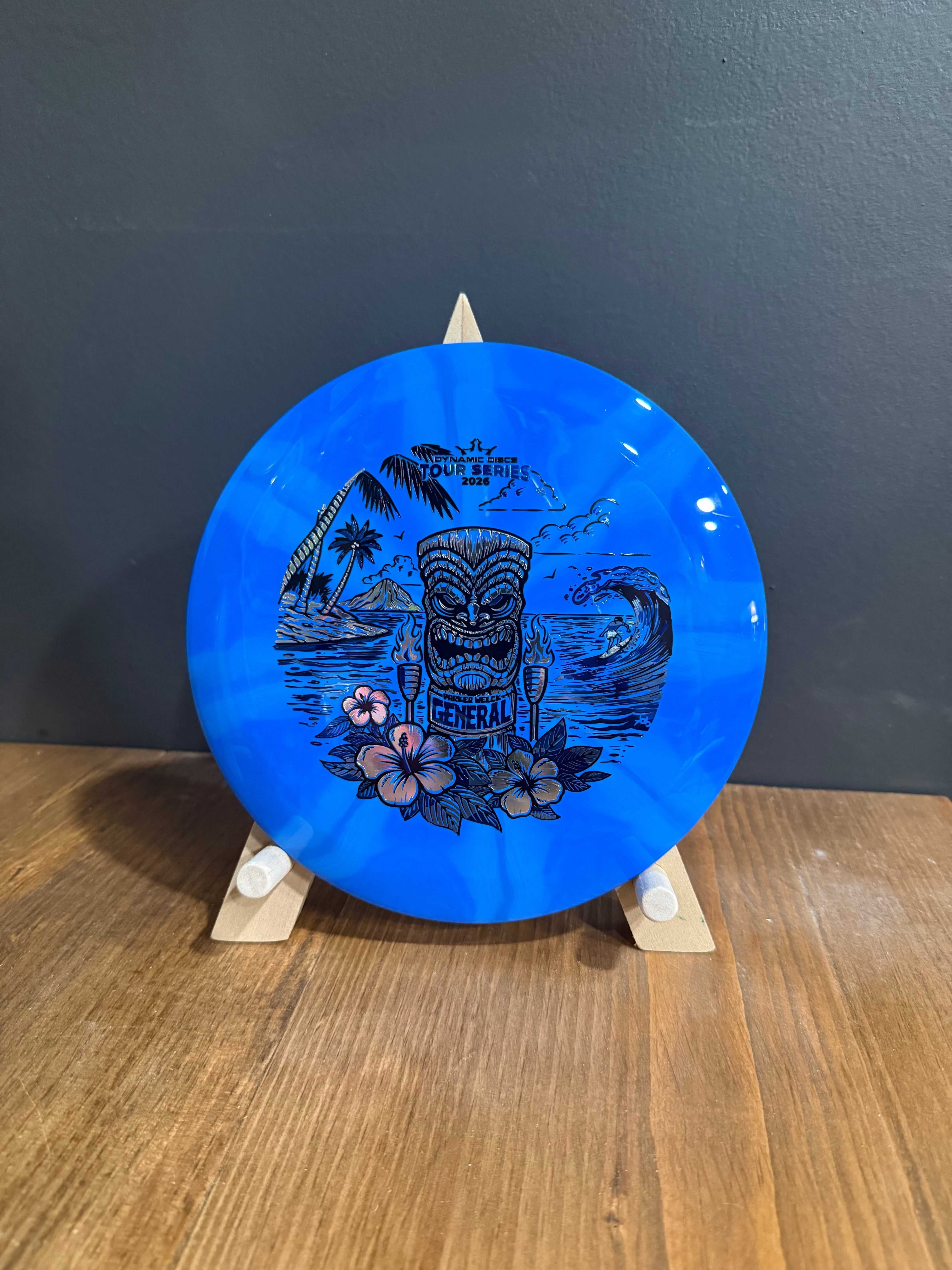 Supreme Burst General disc in bright blue burst plastic with a detailed black tropical island triple-stamp design