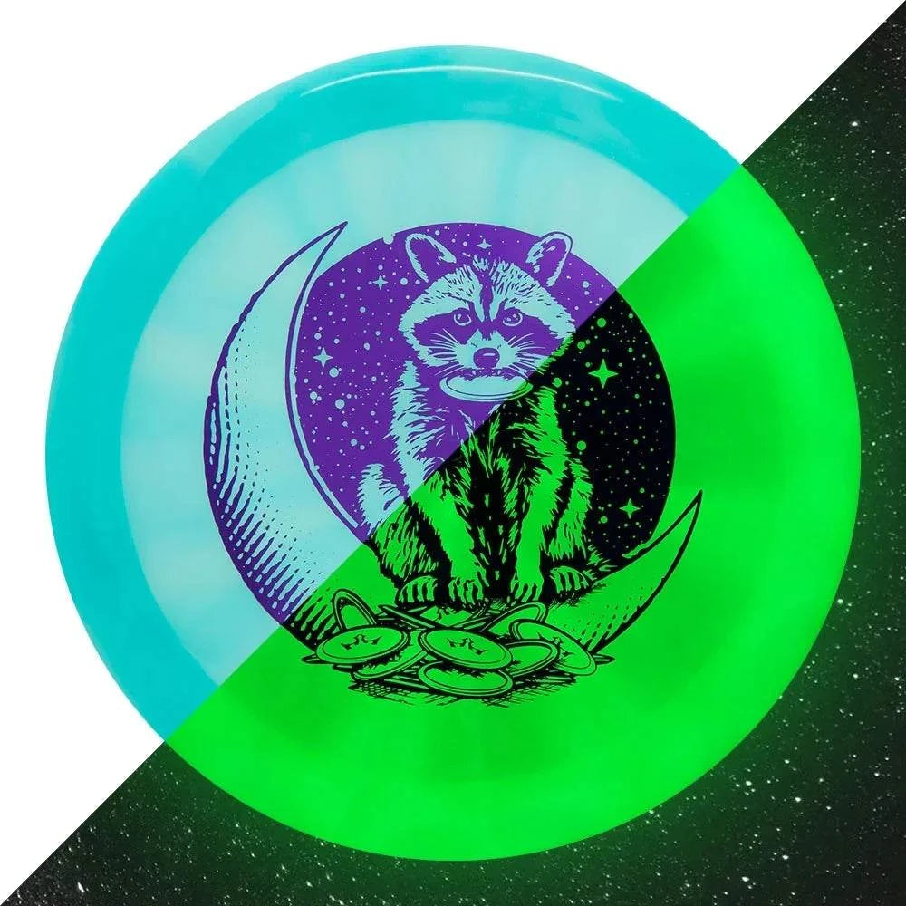 Lucid Burst Moonshine Treason disc in turquoise and neon green with raccoon eclipse artwork and coin details